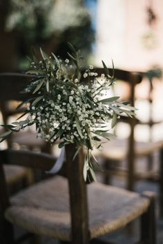 a bouquet of flowers sitting on top of a wooden chair