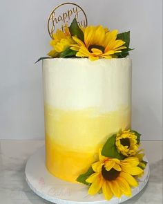 a yellow cake with sunflowers on top