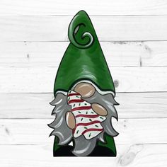 a green gnome's hat with a red and white stripe on it, sitting on top of a wooden wall