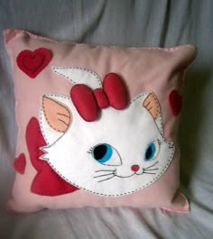 a cat pillow with hearts on it