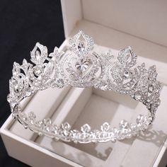 a tiara in a box on a black surface