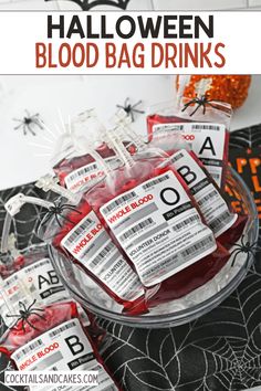 halloween blood bag drinks are on the table with bats and spider webs around them