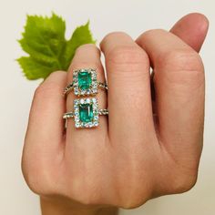 This fantastic Emerald & Apatite ring is the perfect reflection of spring. The color of this central Emerald is gorgeous with exceptional luster. Surrounded by a stunning bright blue Apatite border, the unexpected combination is exciting.  Emeralds have been made into jewelry for centuries. It symbolizes renewal an Fine Jewelry Turquoise Sapphire Ring With Accent Stones, Turquoise Sapphire Ring With Accent Stones, Emerald Cut Gemstones With Halo Setting, Radiant Cut Gemstone Halo Ring, Emerald Gemstones With Halo Setting Fine Jewelry, Blue Emerald Ring With Halo Setting, Blue Emerald Rings With Halo Setting, Blue Emerald Halo Setting Ring, Turquoise Gemstone Rings With Emerald Cut