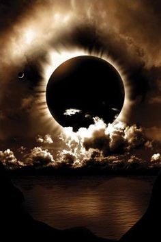 an eclipse is seen in the sky with clouds and water around it, as well as two moon's