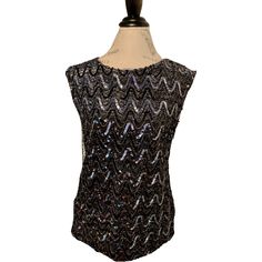 Teddi Of California's women's black sequin top Sleeveless Good condition, size M A few pulled threads Detailed measurements: Bust - 36 inches Waist - 34 inches More vintage clothing: https://www.etsy.com/shop/ElectricEyeThrift?sort_order=price_desc%C2%A7ion_id§ion_id=27044881 ✶ VINTAGE ✶ Please note that this item is vintage. Wear and tear representative of its age may be present. Anything major will be in the description, but please look closely at the photos. Feel free to send me a message or Black Sequin Tank Top, Black Sequin Top, Sequin Tank Top, Sequin Tank, Sequin Tank Tops, Beaded Top, Sequin Beading, Sequin Top, Top Sleeveless