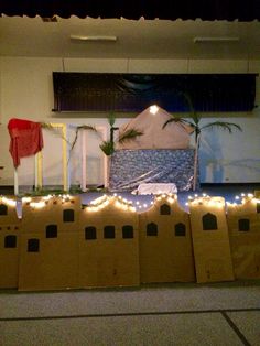 several cardboard boxes are lined up in front of a bed with lights on the sides