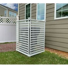 a white trellis in front of a house