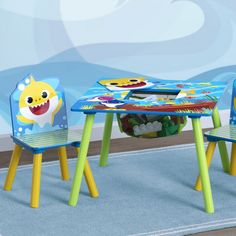 a child's table and chairs with shark pictures on them