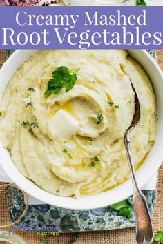 creamy mashed root vegetables in a white bowl with a spoon and parsley on top