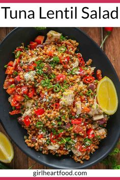 a plate full of tuna lentil salad with lemon wedges