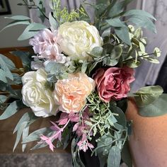 a vase filled with lots of flowers on top of a table