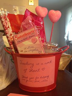 a valentine's day gift basket with candy, candies and other items in it