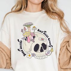 Express your unique style with our Dead Inside But Still Groovy shirt. Featuring a quirky mushroom skull design, this shirt is perfect for those who embrace their dark humor while staying effortlessly cool. Ideal for casual wear or as a gift for friends who appreciate a blend of edginess and grooviness. Casual Long Sleeve Top With Mushroom Design, Fun Skull Print Crew Neck T-shirt, Fun Cotton Tops With Skull Print, Casual Crew Neck T-shirt With Mushroom Design, Relaxed Fit Tops With Mushroom Print For Streetwear, Relaxed Fit Mushroom Print Top For Streetwear, Casual Mushroom Design T-shirt For Fall, Casual Fall T-shirt With Mushroom Design, Casual Cotton Tops With Mushroom Print