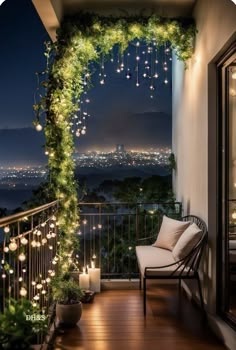 a balcony decorated with christmas lights and greenery at night, overlooking the city skyline