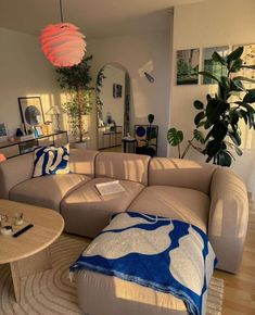 a living room filled with furniture and a large lamp hanging over the top of it