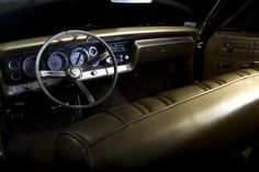 the interior of an old car with dashboard and gauges on it's dash board