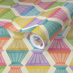 an abstract wallpaper with multicolored geometric shapes on white paper and a roll of tape