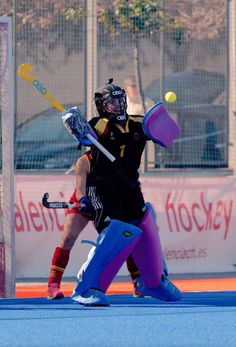 a person on a field with a ball in their hand and a racket in the other hand