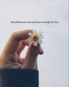 someone holding a flower in their hand with the words, al ah knows me and that's enough for me