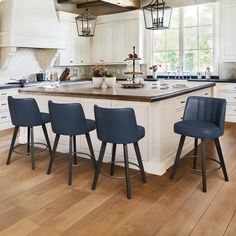 a kitchen island with four stools in front of it and a center island on the other side