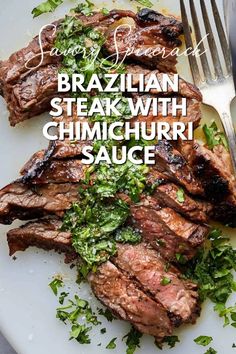 grilled steak with chimichurri sauce on a white plate next to a fork