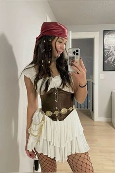 a woman in a pirate costume taking a selfie