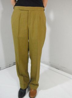 Vintage DAKS greenish brown cuffed trousers, made in England for Albion House Ltd., Lausanne. Fabric is 100% pure wool, inside of trouser pockets lined, inside front of legs lined with silk, 4 rough fabric patches at inside waist which helps shirt stay tucked, inside back of cuff lined to prevent wear. The outside waist buttons have a short elastic band for a little extra room. No wear or tear, no stains, pristine. Length of trousers 40in. Person wearing the trousers if 5ft6in, weighs 125lbs. & Brown Pants For Tailoring With Belt Loops, Classic Olive Pants With Pockets, Brown Full-length Pants For Semi-formal Occasions, Brown Tapered Leg Pants For Tailoring, Formal Khaki Trousers, Brown Dress Pants With Welt Pockets, Brown Full-length Dress Pants For Semi-formal Events, Retro Cotton Trousers, Vintage Wool Pants For Formal Occasions