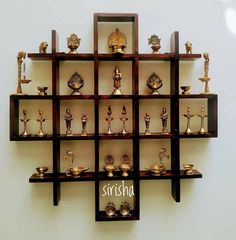 a wall mounted shelf filled with lots of trophies