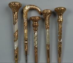 four gold and white canes are lined up