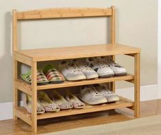 a wooden shoe rack with several pairs of shoes on it