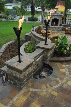 an outdoor patio with fire pit and seating area