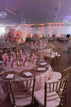 the tables are set up with pink flowers and place settings for dinner or wedding guests