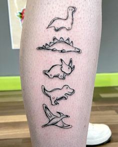 a woman's leg with four different animals on the legs and one is in black ink