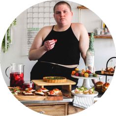 a woman standing in front of a table filled with food