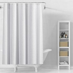 a bathroom with a white shower curtain and shelves on the wall next to the bathtub