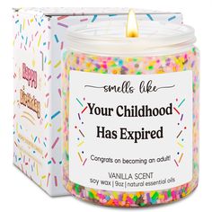 a small jar filled with sprinkles next to a box of birthday candles