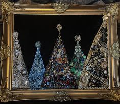 three christmas trees made out of buttons in a gold frame on a black background,