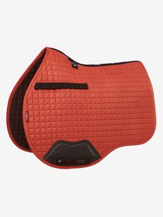 an orange saddle pad with black piping