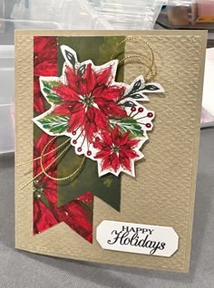 a christmas card with poinsettis on it and a tag that says merry holidays