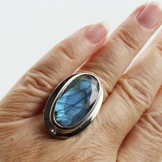 "Sky blue beautiful cut stone Labradorite ring long oval shape oval cut faceted stone set on 925 sterling silver amazing quality jewelry solid silver handmade All jewelry are made of quality genuine stones and crystals...  925 genuine solid silver and nickel free, quality solid silver 925  The rings are solid and durable and the setting is flawless, handmade hypoallergenic jewelry...  i choose every stones with great attention, love and inspiration to offer nature's beauty for all of you  Dimensions Stone : 24 x 14 mm Length : 31 mm (1.22\") Width : 20 mm (0.79\") Height : 10 mm (0.39\") Weight : 21.4 grams Size fits : 6.5 to 7 US, CA / 53 to 54 France / -N- to -O- UK SIZING Resizing available for $20 USD take from 7 to 10 days before shipping" Sterling Silver Jewelry With Large Oval Cabochon Stone, Oval Labradorite Jewelry Stamped 925, Oval Silver Labradorite Jewelry, Modern Oval Sterling Silver Gemstones, Silver Labradorite Oval Jewelry, Modern Jewelry With Large Oval Stone, Oval Faceted Gemstones For Fine Jewelry, Silver Oblong Jewelry Gift, Unique Oval Natural Stones Jewelry