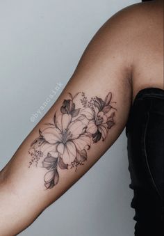 a woman with a flower tattoo on her arm