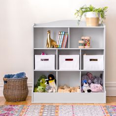 a white book shelf filled with lots of toys