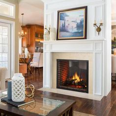 a living room filled with furniture and a fire place under a painting on the wall