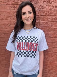 Checkered and Custom to your mascot and school colors?? Let's Go! This is the PERFECT tee to rep to ANY school event! Port and Co 50/50 Professionally Sublimated Unisex and True to Size Model is wearing size small, her true size. School Spirit T-shirt For Game Day, School Spirit T-shirt For Sports Season With Crew Neck, Gray Cotton T-shirt With School Spirit, Collegiate Style School T-shirt With Screen Print, College Gray Logo Print T-shirt, College Style T-shirt For Sports Season Streetwear, College Style Short Sleeve T-shirt For Game Day, Sporty School T-shirt With Graphic Print, Sporty Graphic Print T-shirt For School