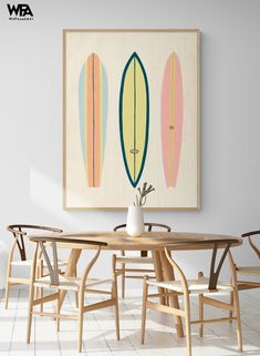 a dining room table with four chairs and a surfboard painting on the wall above it