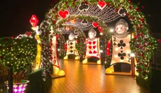 an outdoor deck decorated for christmas with lights and decorations on the sides, including snowmen