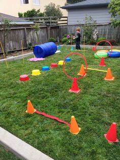 children playing in the yard with plastic cones and obstacles