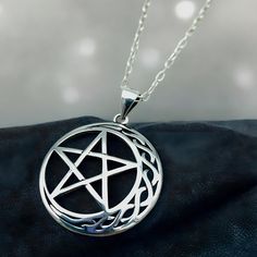 Dive into the celestial enchantment with our handcrafted Celtic Moon & Star Pendant, expertly crafted from the finest 925 Solid Sterling Silver! This exquisite piece is more than just jewelry; it's a miniature masterpiece that captures the mystique of the night. Each pendant, stamped with 925, measures approximately .91 x .91 inches, embodying the perfect blend of ancient symbolism and modern artistry. Complete your look with the optional 18" sterling silver cable link chain, and wear the night sky's allure close to your heart! Satisfaction Guaranteed! Sterling Silver Celestial Pendant Charm Necklace, Sterling Silver Spiritual Charm Necklace With Large Pendant, Mystical Moon Charm Sterling Silver Necklace, Mystical Sterling Silver Necklace With Moon Charm, Mystical Silver Star Jewelry, Mystical Silver Star-shaped Jewelry, Symbolic Silver Star Necklace, Handmade Celestial Sterling Silver Charm Necklace, Mystical Handmade Silver Charm Necklace