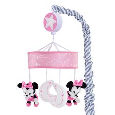 a pink and white baby crib mobile with minnie mouses hanging from it's side