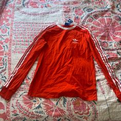 This Is A Long Sleeved Top From Adidas In A Bright Orange Color. Brand New With Tags And Never Worn. Casual Long Sleeve Tops With Three Stripes, Long Sleeve Tops With Three Stripes For Fall, Adidas Long Sleeve Spring Tops, Adidas Long Sleeve Tops For Spring, Casual Three Stripes Tops For Fall, Casual Winter Tops With Three Stripes, Adidas Cotton Long Sleeve Top, Adidas Long Sleeve Cotton Top, Fall Tops With Three Stripes